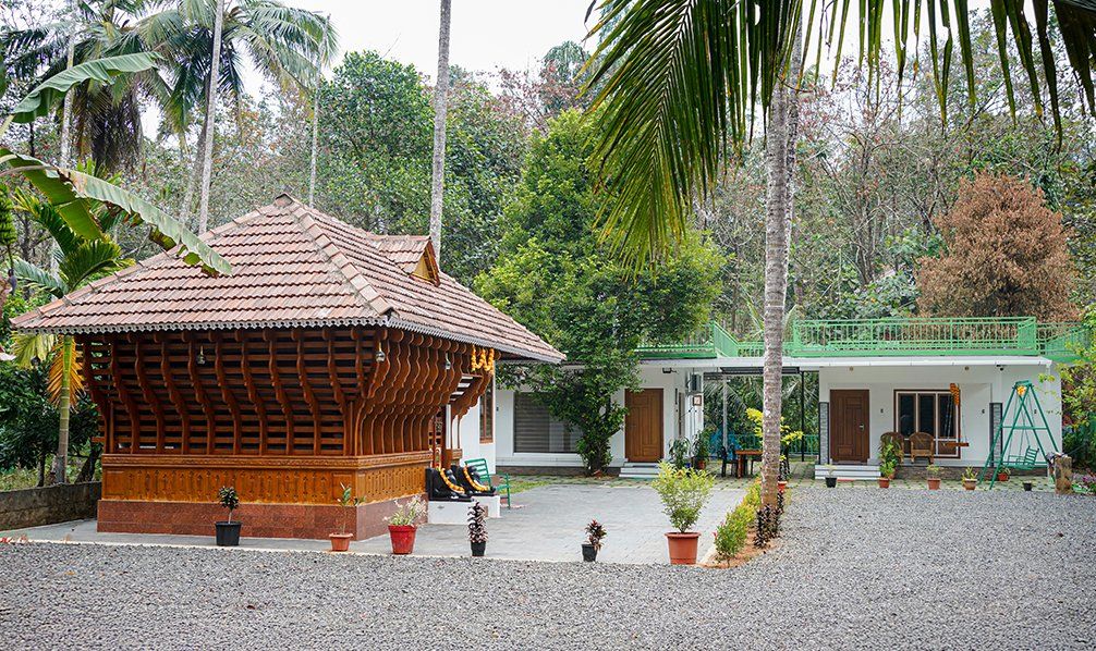 The wooden Kerala cottage and the main house