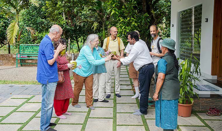 A birding group being welcomed with tender coconuts in the garden