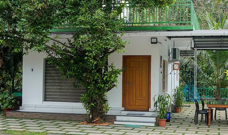 The side of the house with garden seating