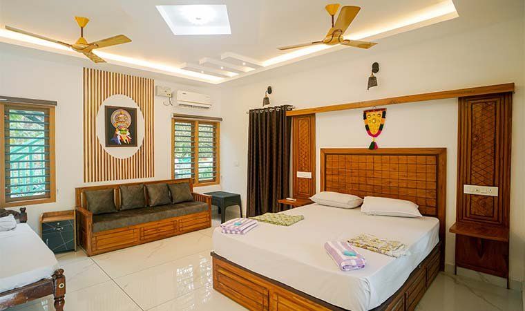 A large room with a sofa, coffee table and double bed