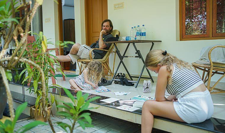 Guests reading and drawing on the verandah